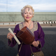 A woman demonstrates a crystal singing bowl at the Tucson Gem show.